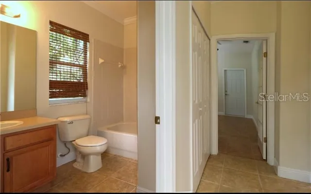 a bathroom with a toilet sink and a shower