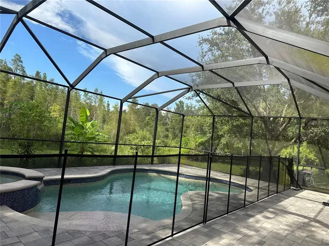 a view of a patio with table and chairs