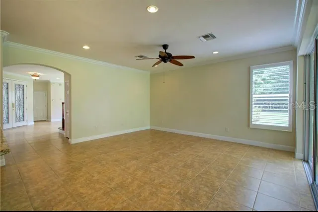 a view of a livingroom with a ceiling fan and window