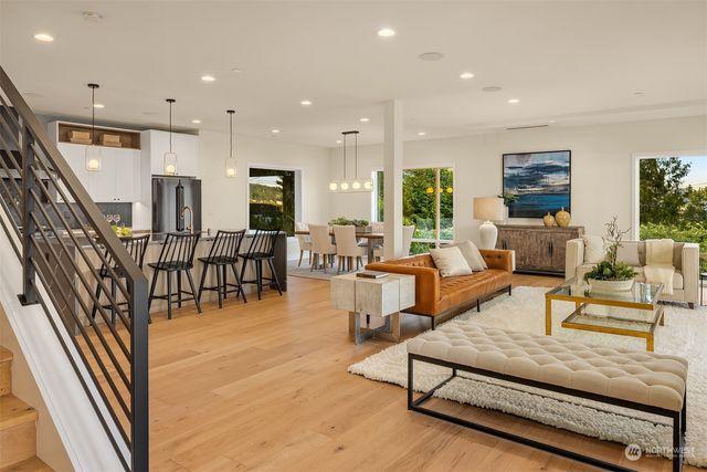 a living room with furniture oven and a flat screen tv