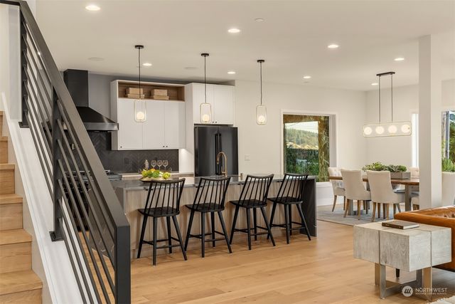 a view of a a dining room with furniture window and wooden floor
