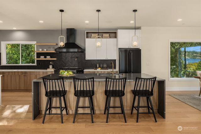a kitchen with a table chairs refrigerator and microwave