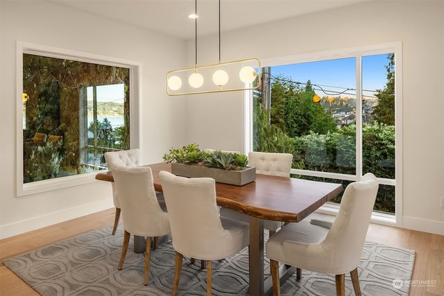 a view of a dining room with furniture window and wooden floor
