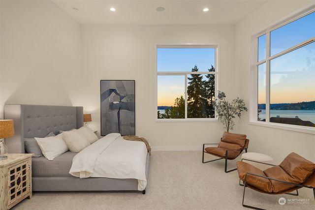 a living room with furniture flowerpot and a mirror