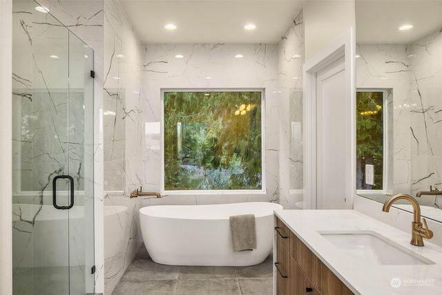 a bathroom with a granite countertop sink a toilet and shower