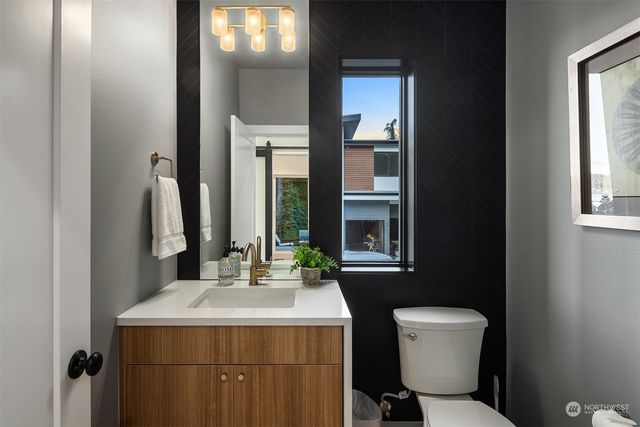 a bathroom with a sink toilet and mirror