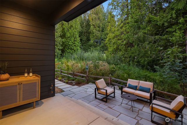 a backyard of a house with outdoor seating
