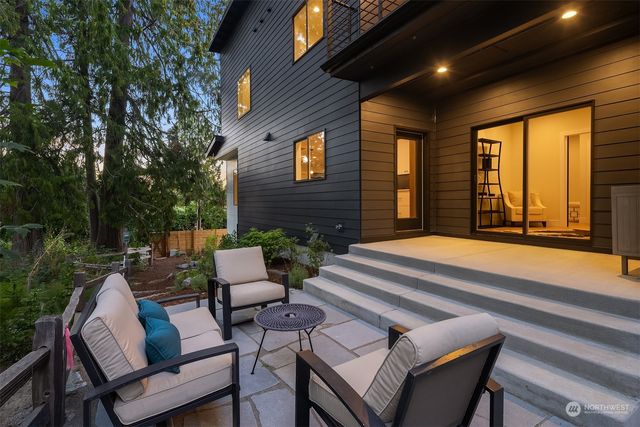 a view of house with backyard and seating area