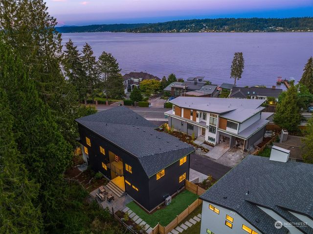 an aerial view of a house with outdoor space and lake view