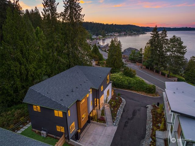 an aerial view of multiple houses with a yard