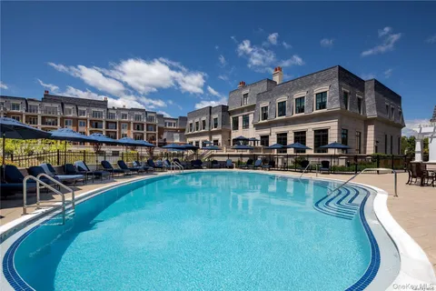 a view of a swimming pool with outdoor seating