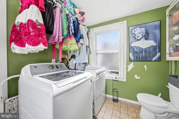 a view of bathroom with a sink toilet and mirror