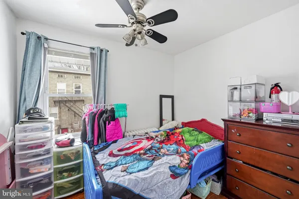 a bedroom with a bed and a dresser in it