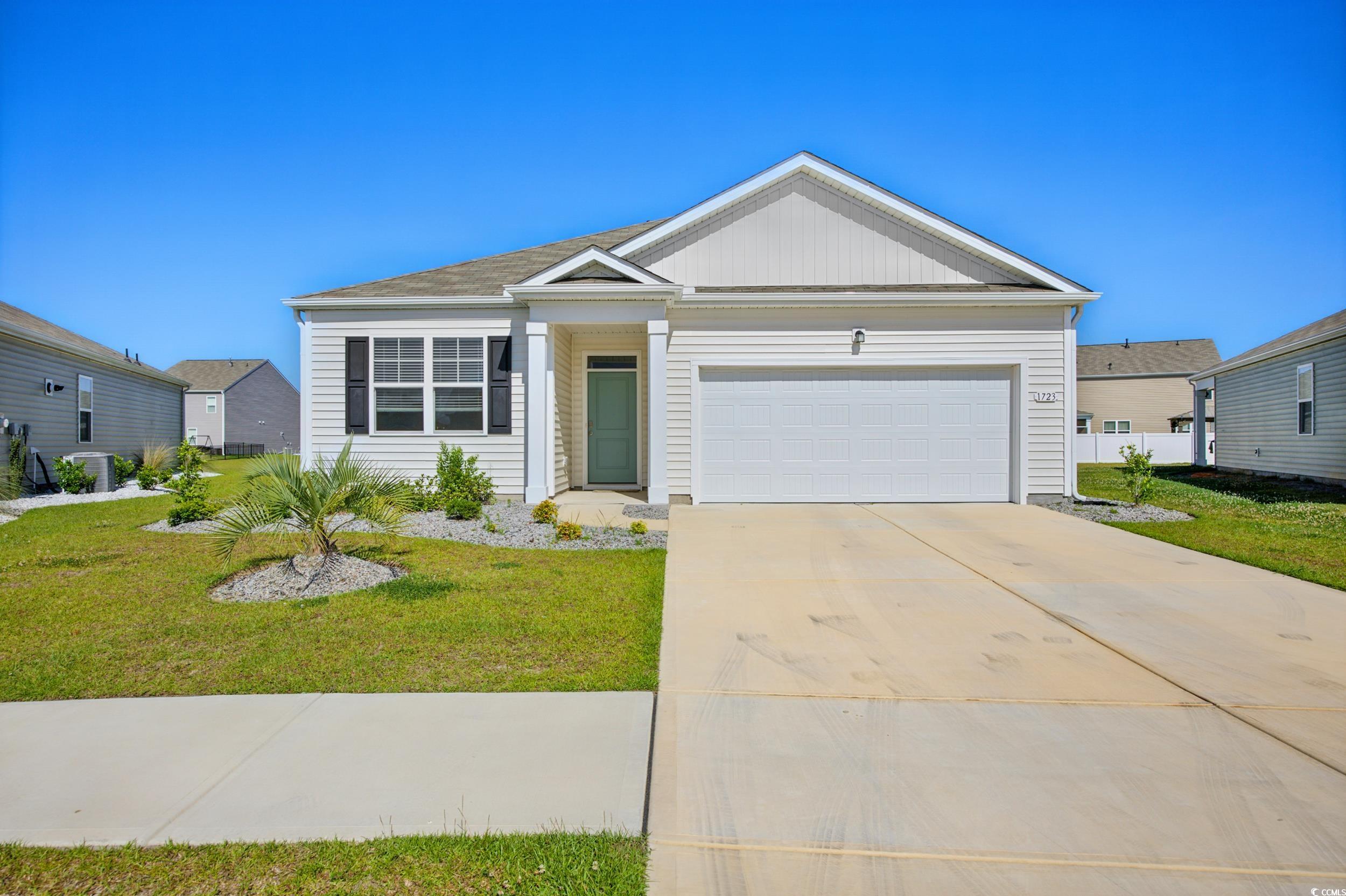 1723 Perthshire Loop Myrtle Beach, SC 29579 - Photo 1 of 34 View of front of house featuring a front yard, an attached garage, and concrete driveway