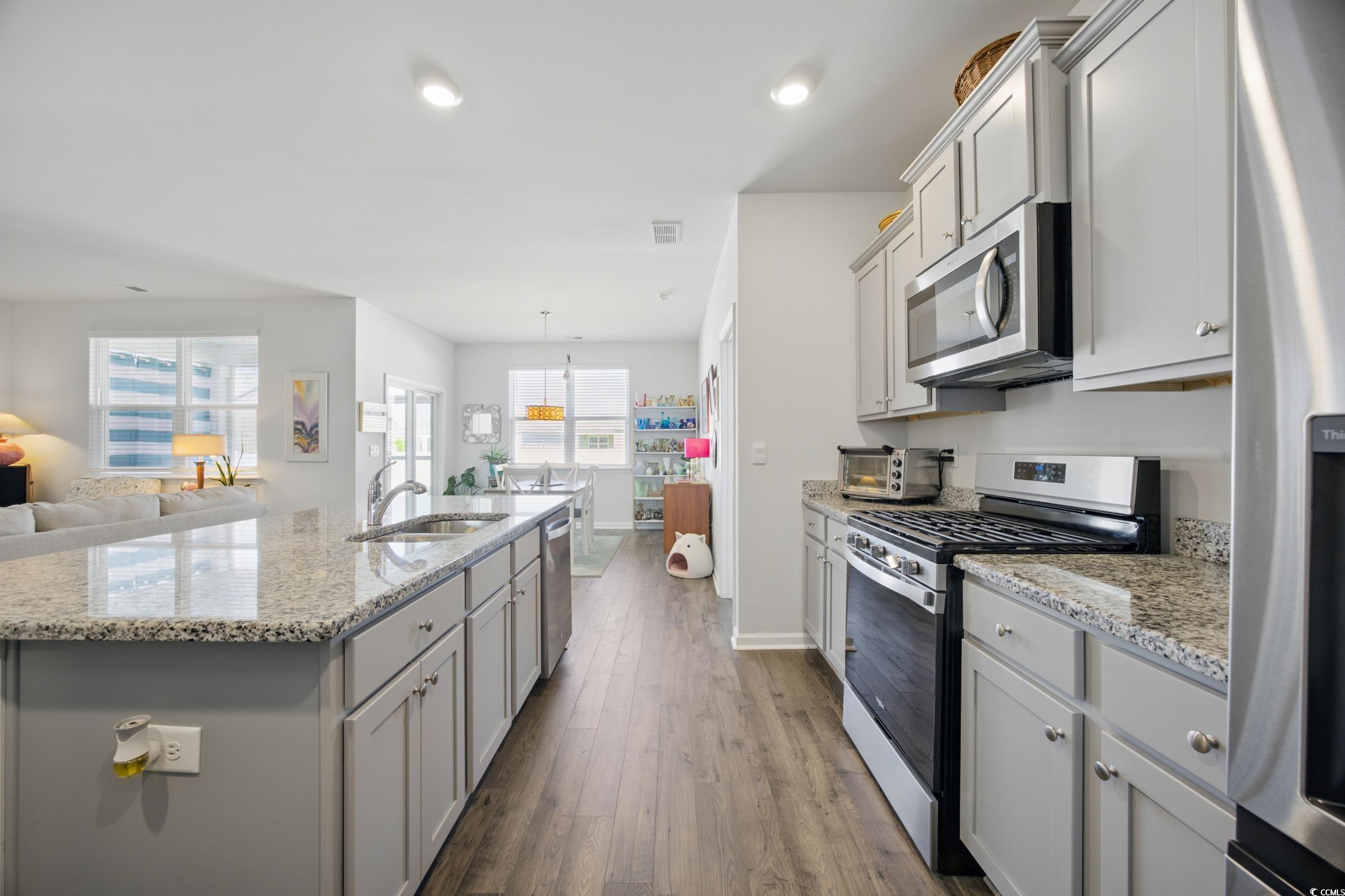 1723 Perthshire Loop Myrtle Beach, SC 29579 - Photo 33 of 34 Kitchen with appliances with stainless steel finishes, a sink, gray cabinets, open floor plan, and recessed lighting