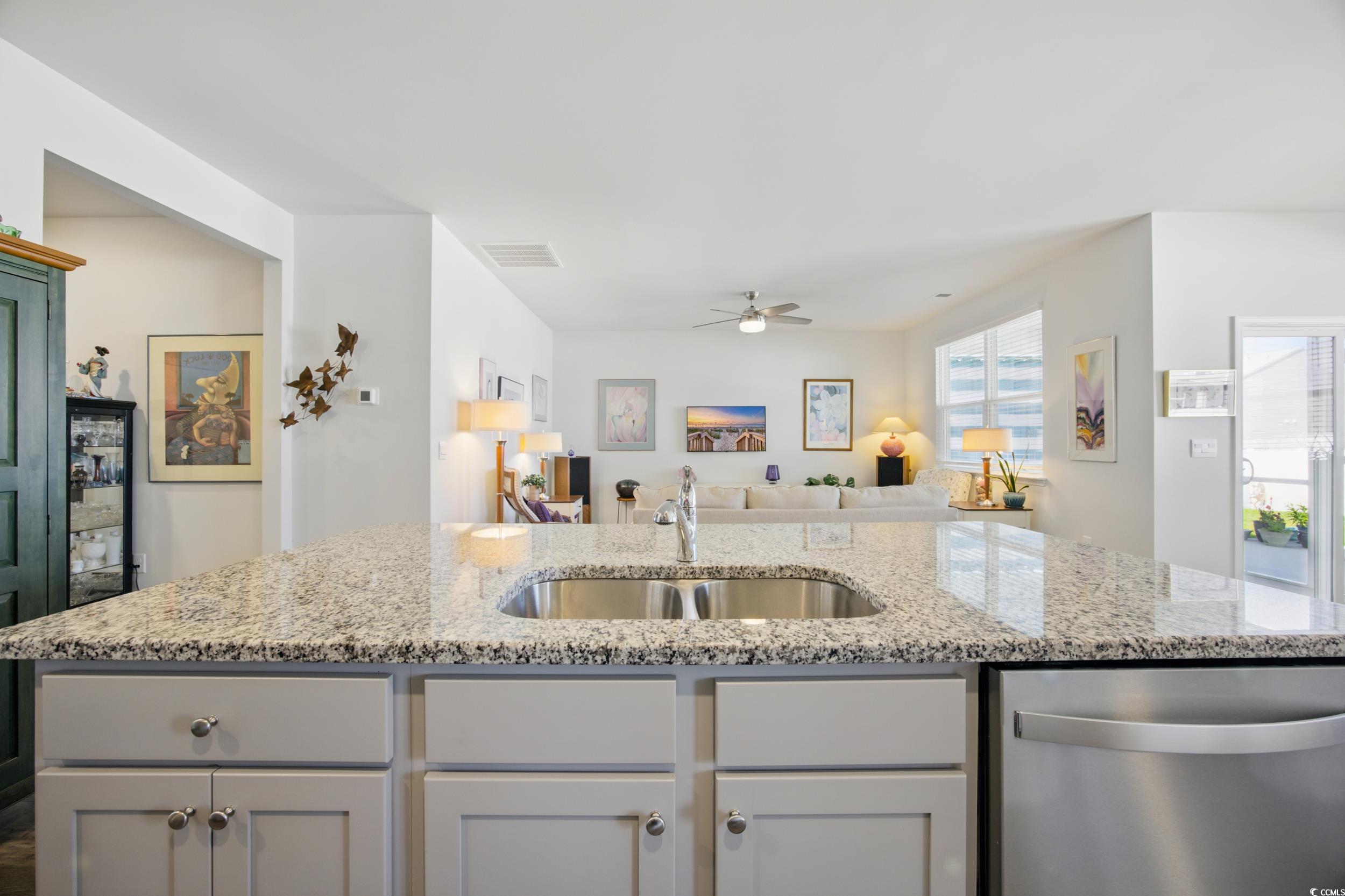 1723 Perthshire Loop Myrtle Beach, SC 29579 - Photo 34 of 34 Kitchen featuring stainless steel dishwasher, a sink, open floor plan, ceiling fan, and light stone counters