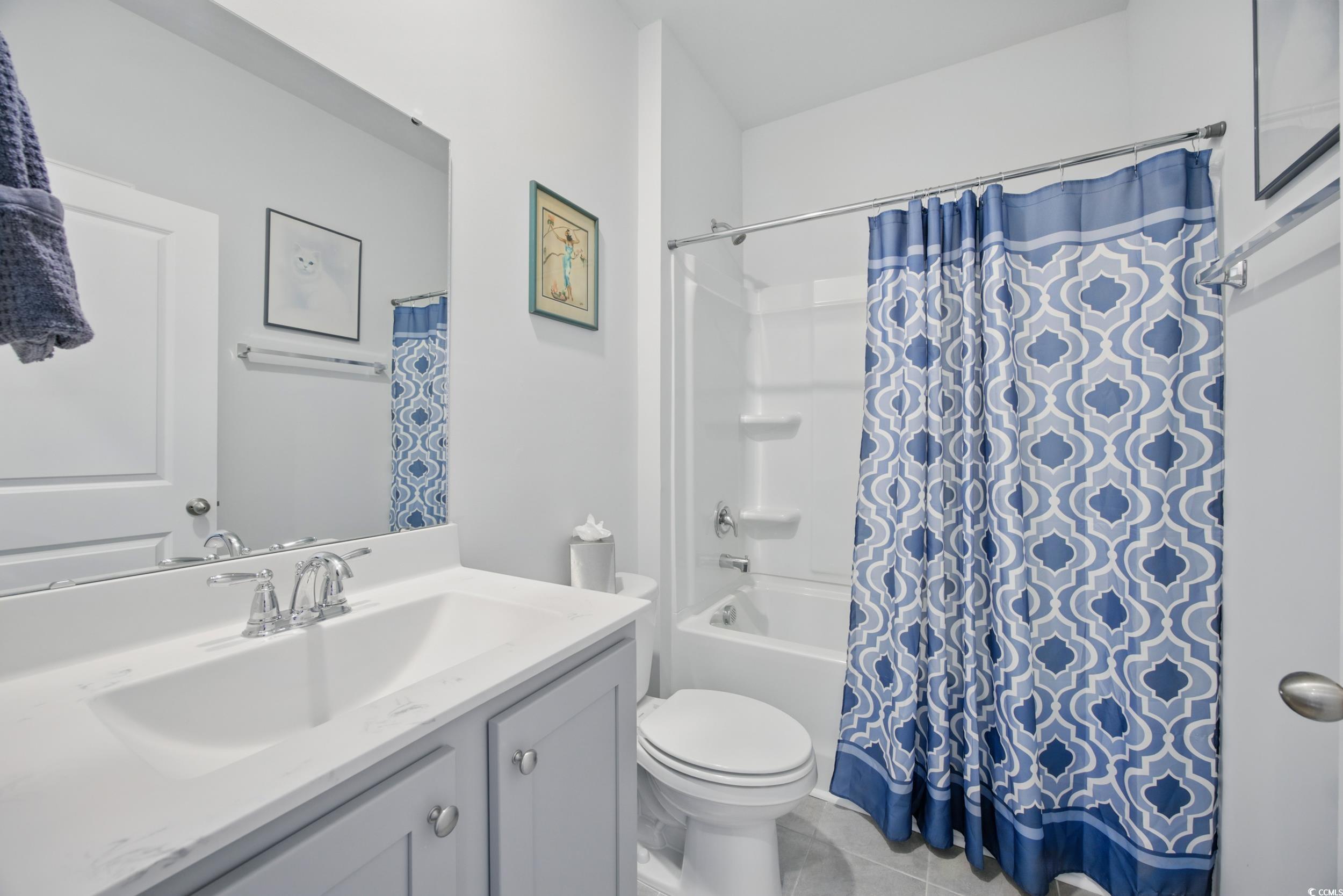 1723 Perthshire Loop Myrtle Beach, SC 29579 - Photo 7 of 34 Bathroom featuring vanity, toilet, shower / tub combo, and tile patterned flooring