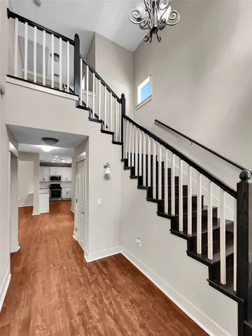 a view of entryway and hall with wooden floor