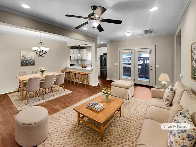 a living room with furniture a rug and a chandelier