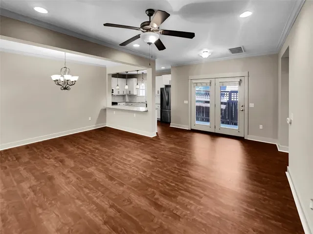 a view of a livingroom with hardwood floor and a ceiling fan