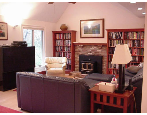 192 East Emerson Road Lexington, MA 02420 - Photo 13 of 16 a living room with furniture a bookshelf and a fireplace