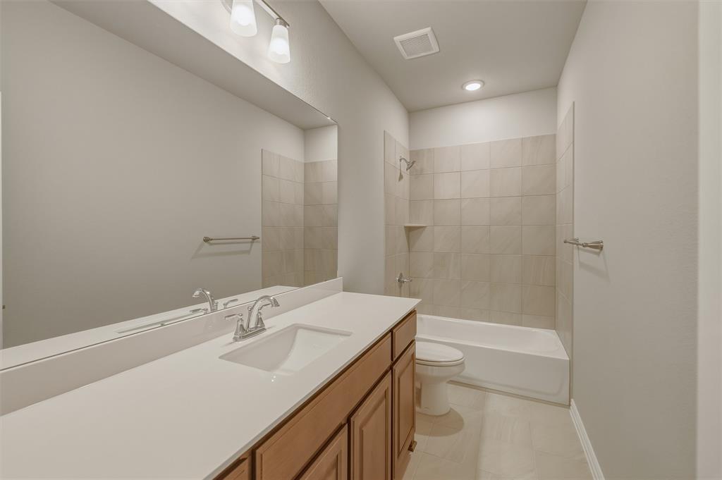 1209 Colca Drive Springtown, TX 76082 - Photo 14 of 24 Full bathroom featuring an integrated sink, wood-finish vanity, and a rectangular mirror