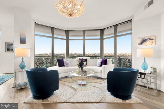 a living room with couches and a coffee table with garden view