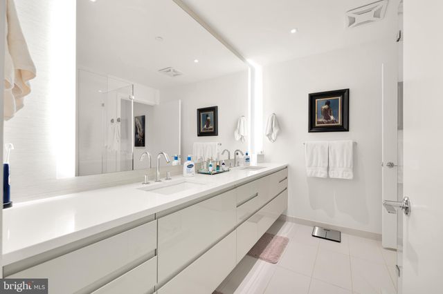 a bathroom with a sink a mirror and a shower