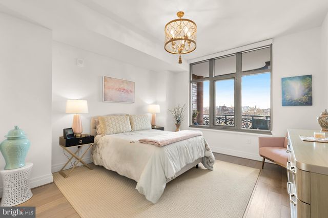 a bedroom with a bed and a chandelier