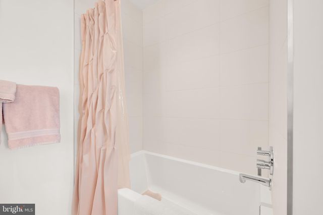 a bathroom with a bathtub and shower