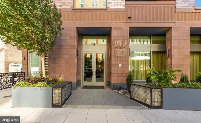 a living room with furniture and large windows