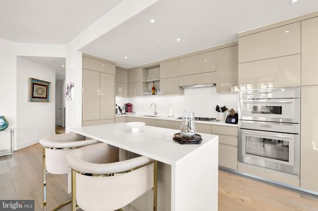 a kitchen with a stove a sink and a refrigerator