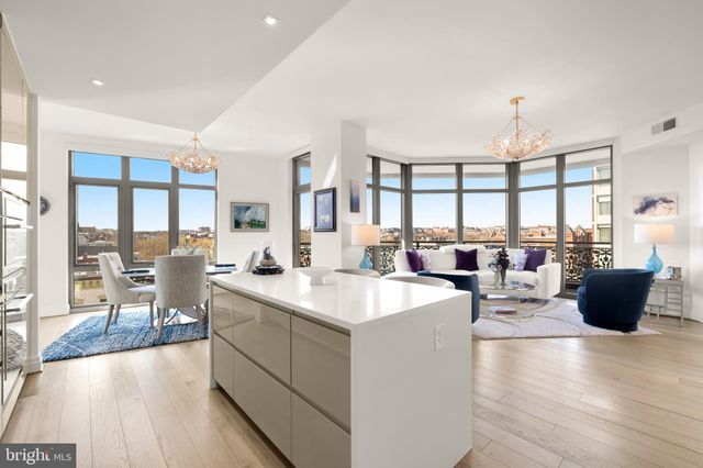 a living room with furniture a dining table and chairs