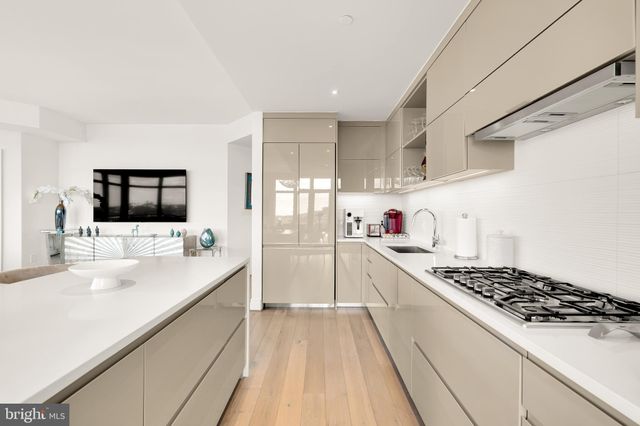a kitchen with sink stove and cabinets