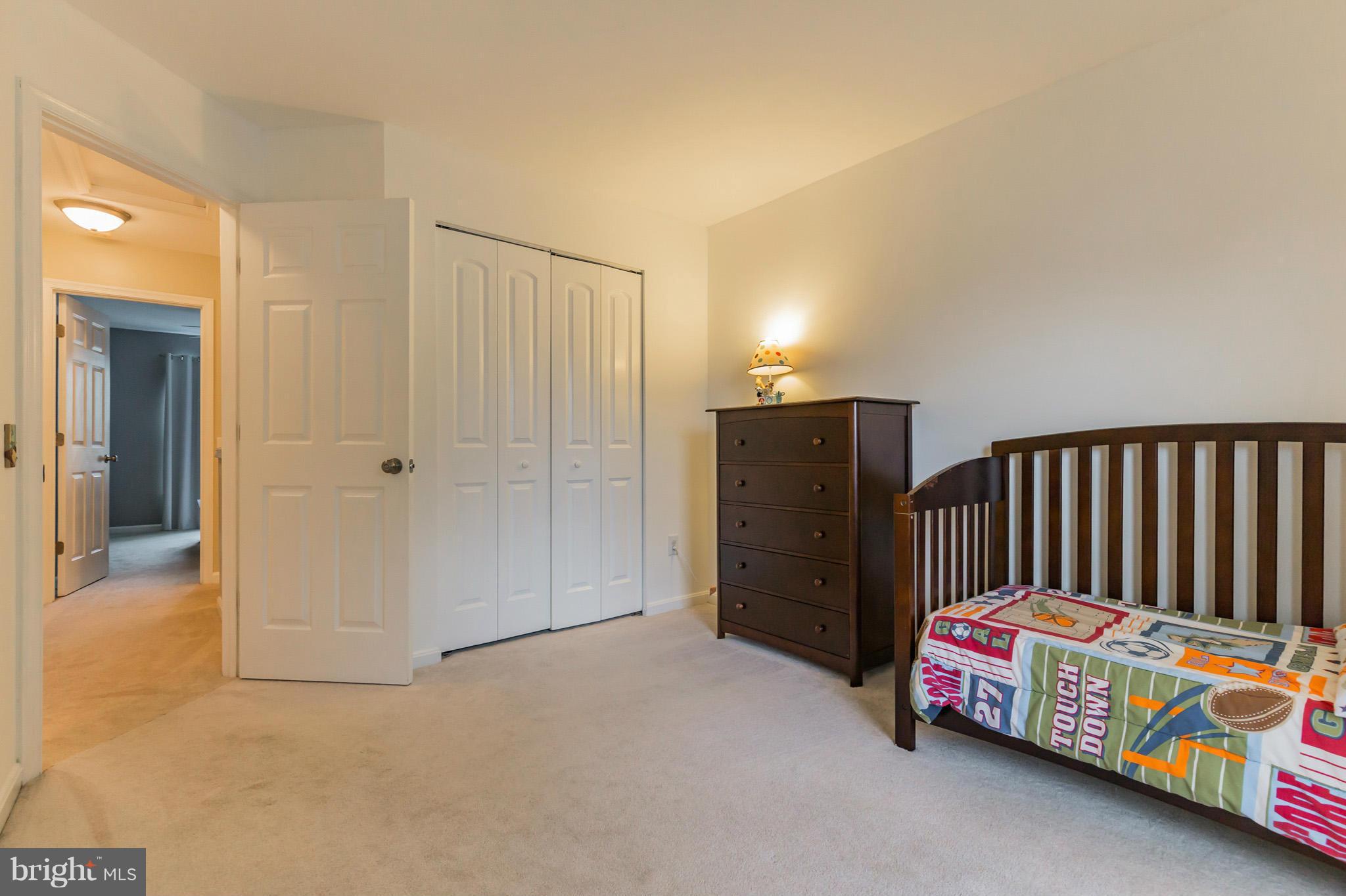 4436 Cole Farm Road Baltimore, MD 21236 - Photo 23 of 30 a bedroom with bed and cabinets