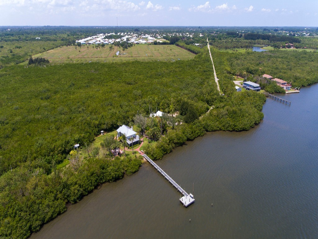 1935 Quay Dock Road Vero Beach, FL 32967 - Photo 1 of 36 a view of a lake with a mountain in the back