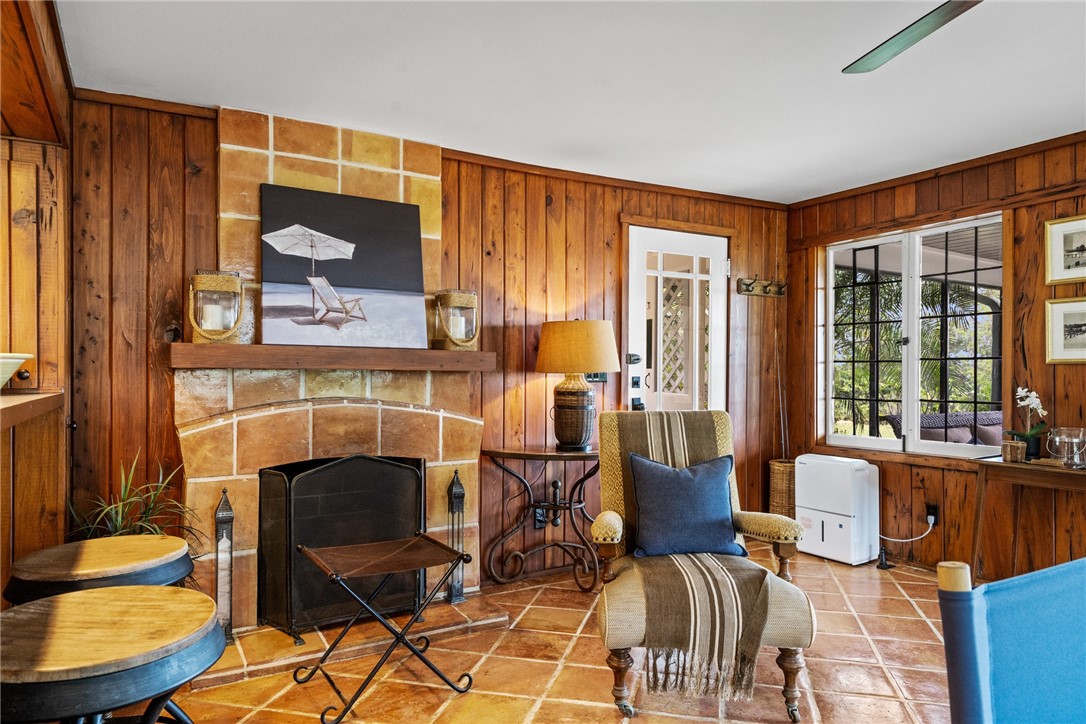 1935 Quay Dock Road Vero Beach, FL 32967 - Photo 12 of 36 a living room with furniture a fireplace and a floor to ceiling window