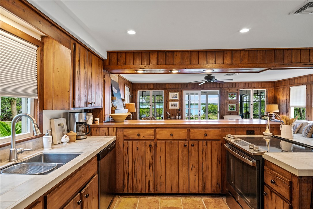 1935 Quay Dock Road Vero Beach, FL 32967 - Photo 14 of 36 a kitchen with large windows and sink