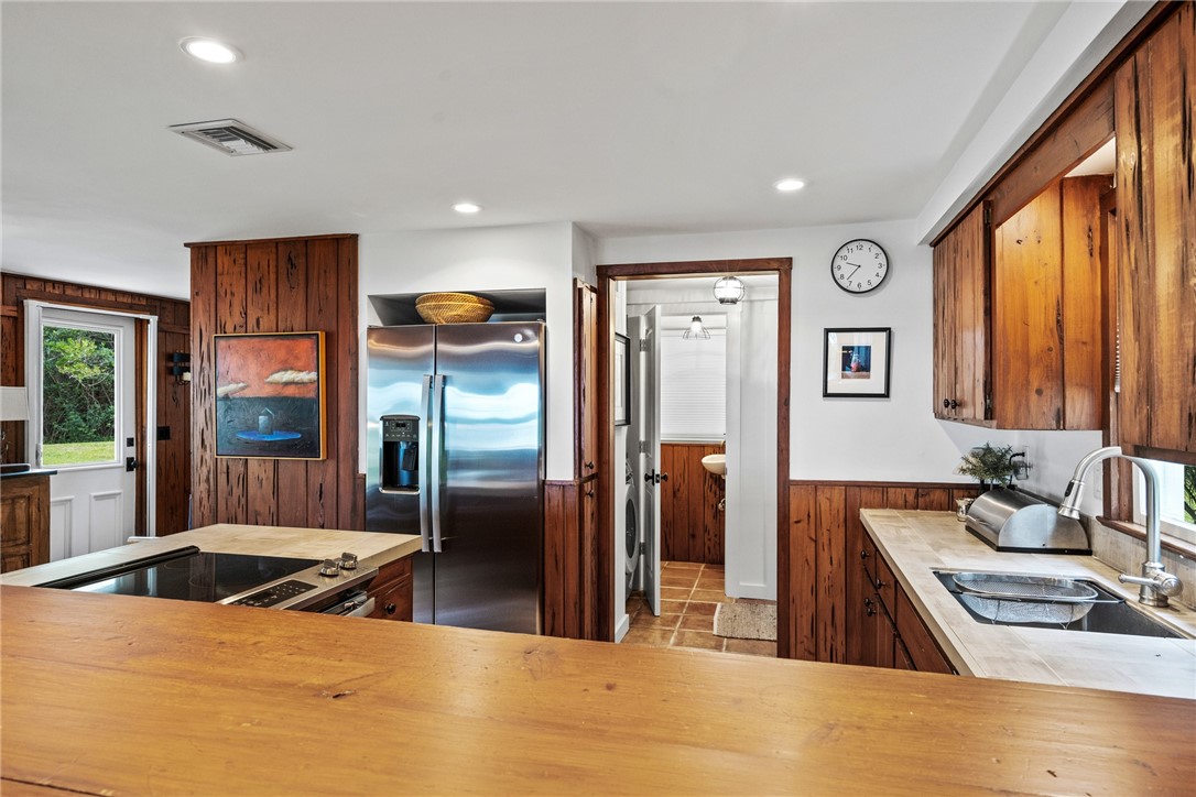 1935 Quay Dock Road Vero Beach, FL 32967 - Photo 16 of 36 a kitchen with stainless steel appliances granite countertop a sink stove and refrigerator