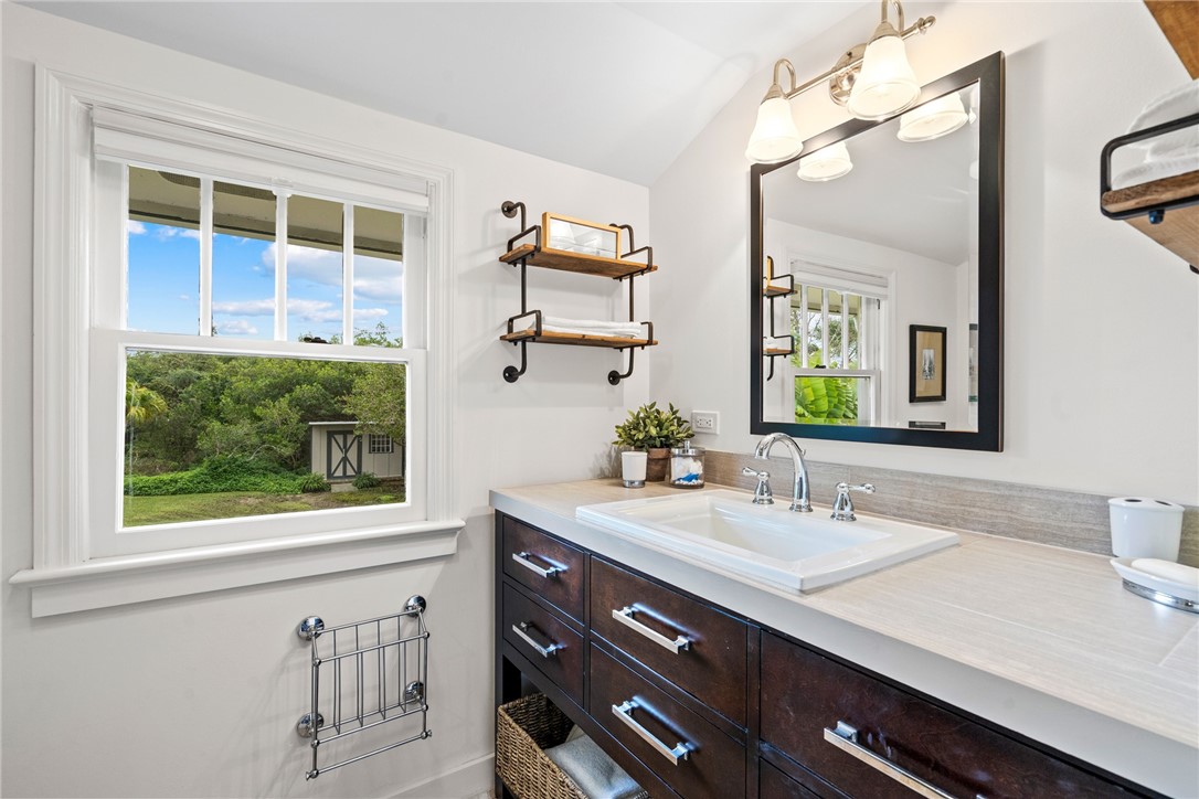 1935 Quay Dock Road Vero Beach, FL 32967 - Photo 27 of 36 a bathroom with a sink vanity and a mirror