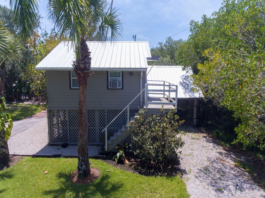 1935 Quay Dock Road Vero Beach, FL 32967 - Photo 29 of 36 a house that has a tree in front of it