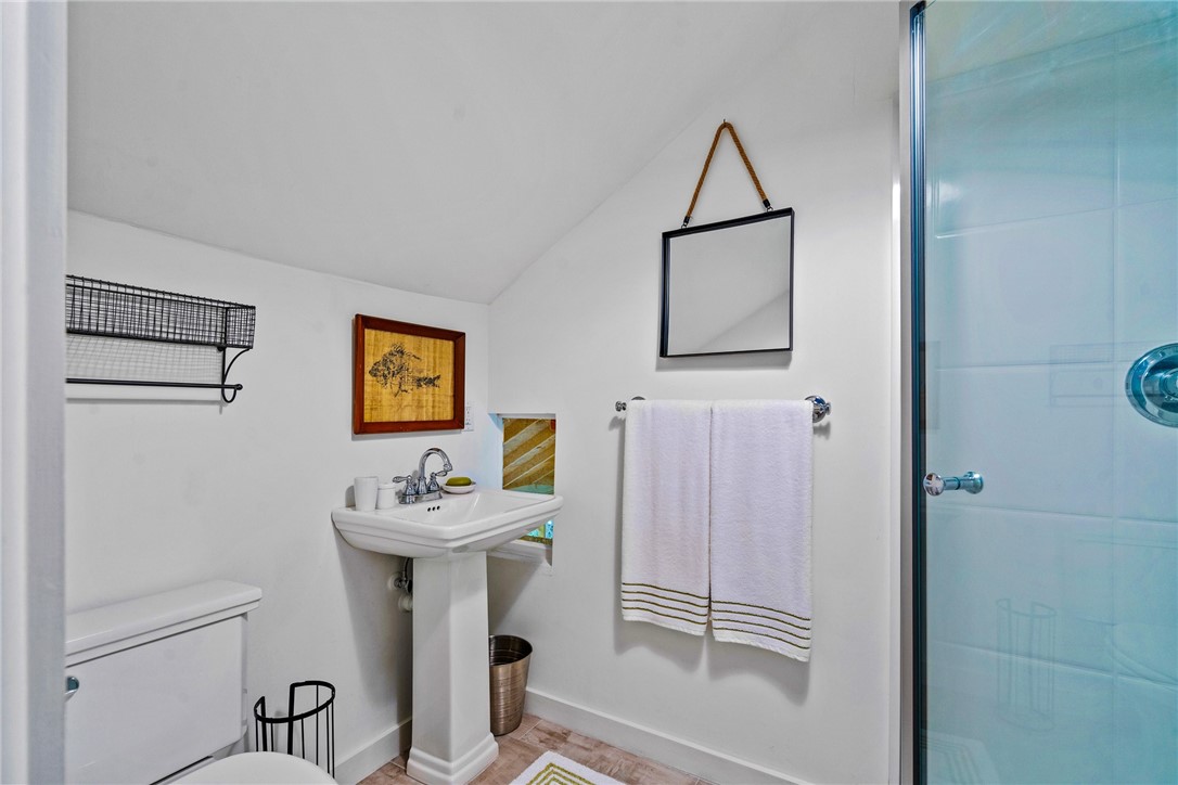1935 Quay Dock Road Vero Beach, FL 32967 - Photo 33 of 36 a bathroom with a sink mirror and a shower