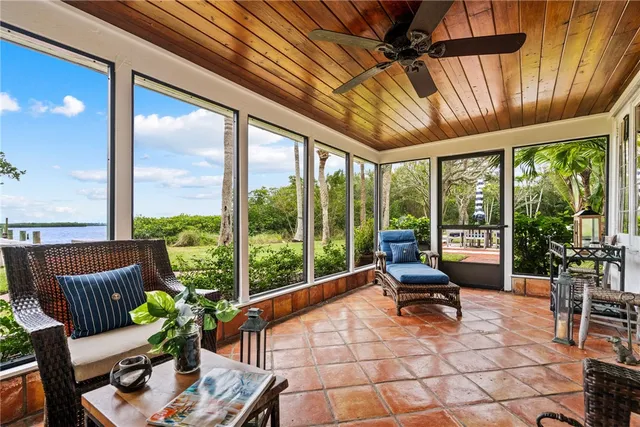 a living room with lots of furniture and a large window