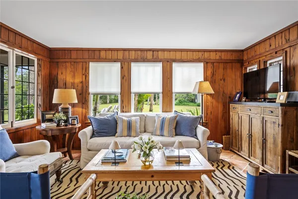 a living room with furniture a fireplace and a large window