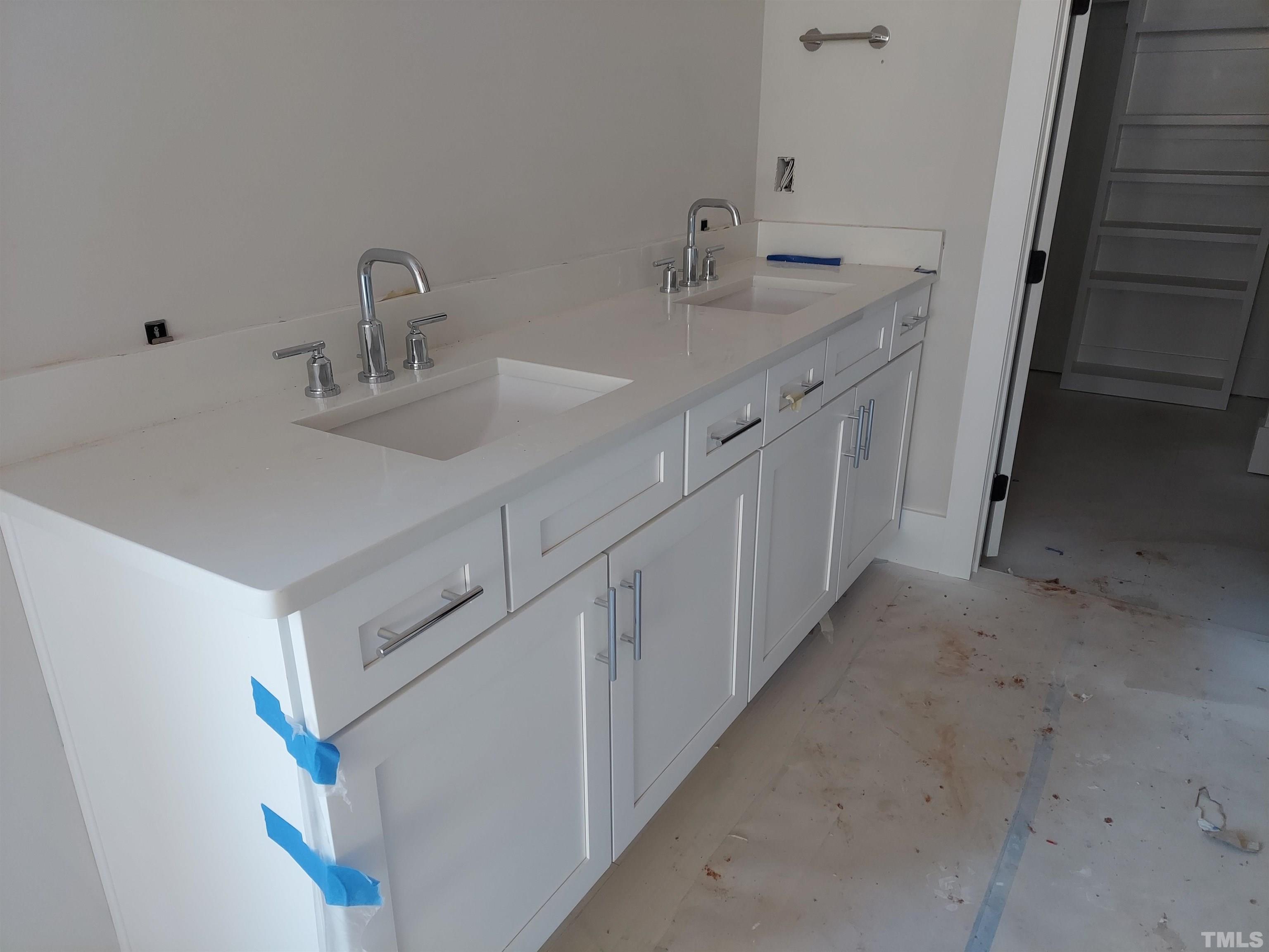 2268 Duskywing Drive Raleigh, NC 27613 - Photo 4 of 4 a bathroom with double vanity sink and a mirror
