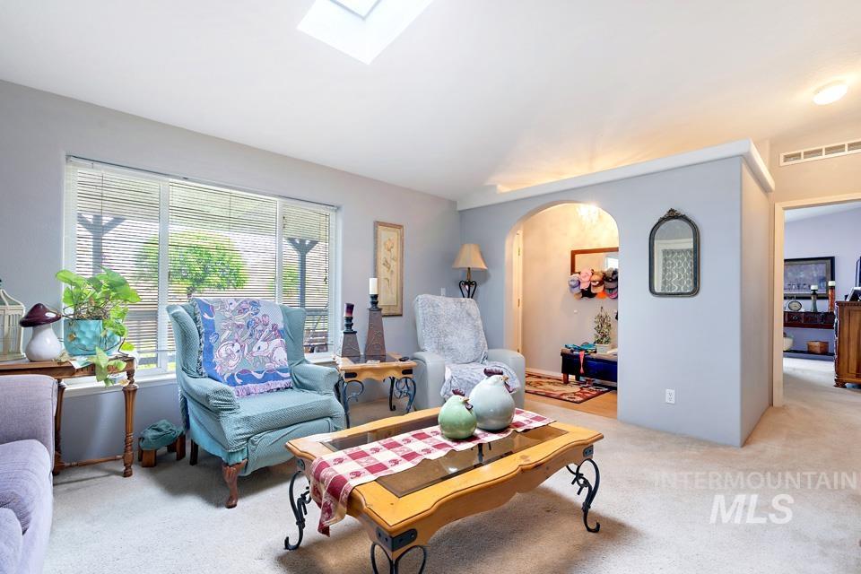 1780 Sand Hollow Road Vale, OR 97918 - Photo 16 of 41 Carpeted living room featuring a skylight and arched walkways