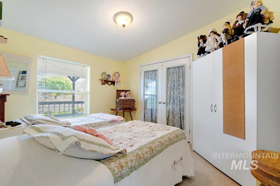 1780 Sand Hollow Road Vale, OR 97918 - Photo 32 of 41 Bedroom featuring french doors, carpet flooring, a closet, and lofted ceiling