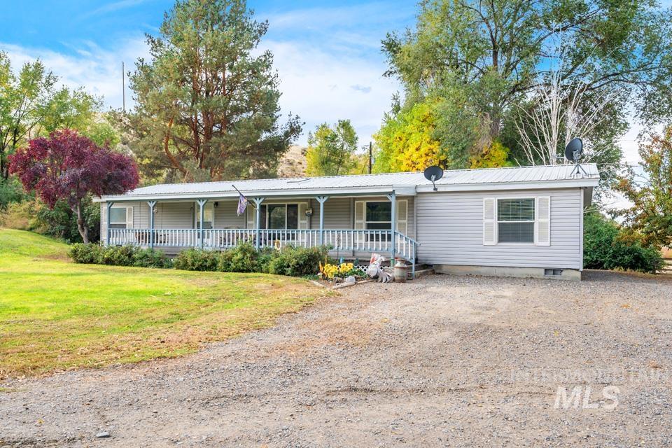 1780 Sand Hollow Road Vale, OR 97918 - Photo 5 of 41 View of front of house with covered porch, a front lawn, and a metal roof