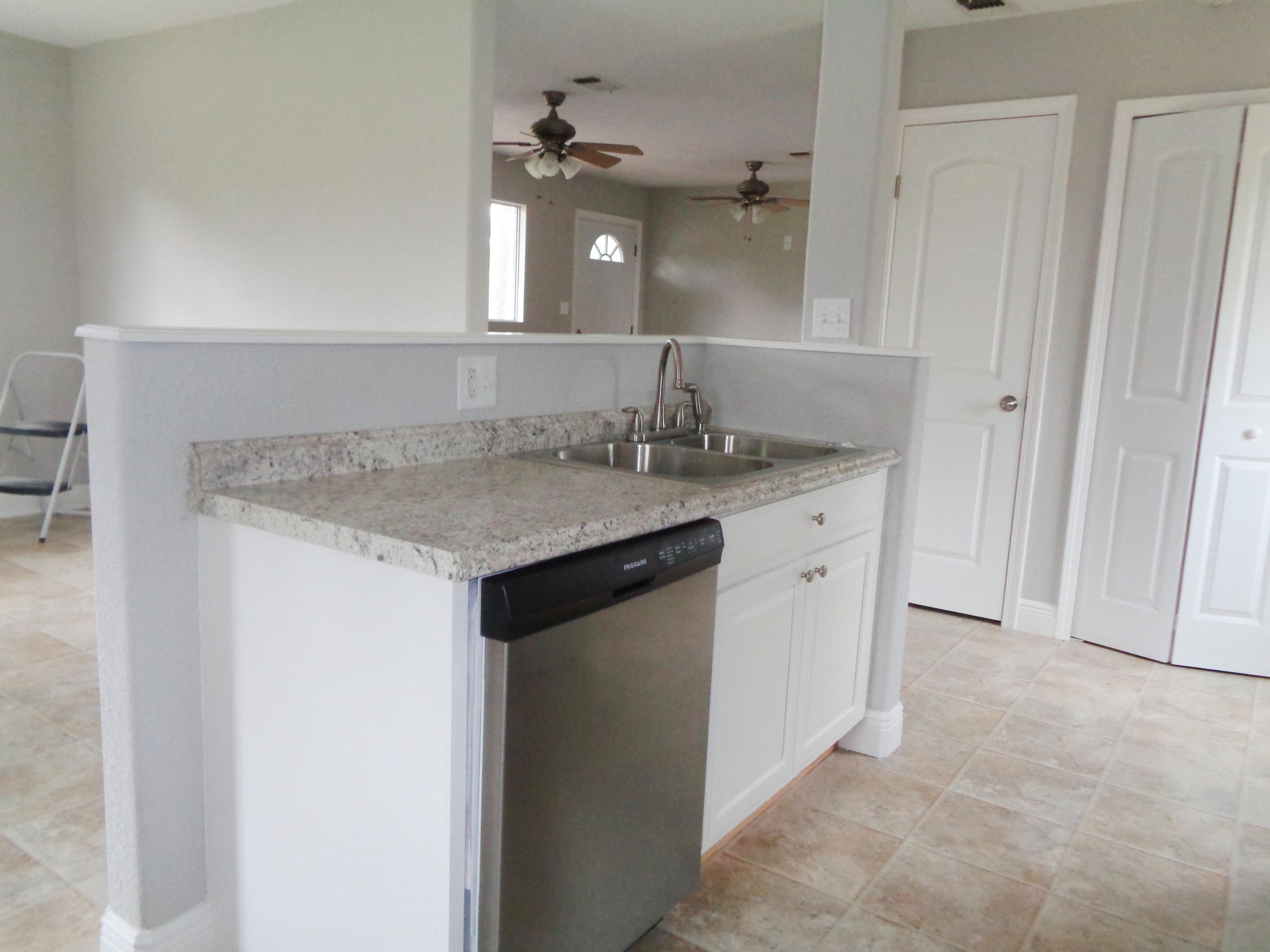 3841 King Lake Road DeFuniak Springs, FL 32433 - Photo 5 of 16 a bathroom with a granite countertop sink and a mirror