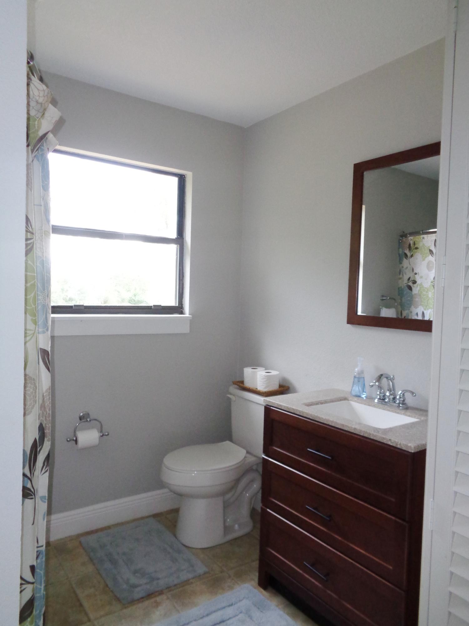 3841 King Lake Road DeFuniak Springs, FL 32433 - Photo 8 of 16 a bathroom with a toilet sink and mirror